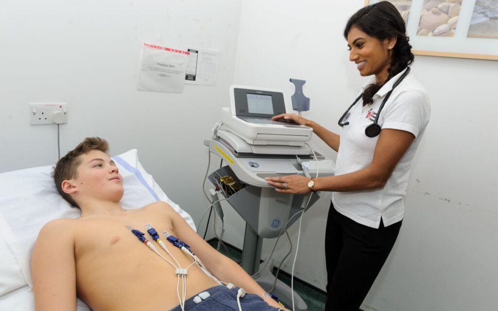 Young person undergoing ECG cardiac screening to prevent sudden cardiac death.