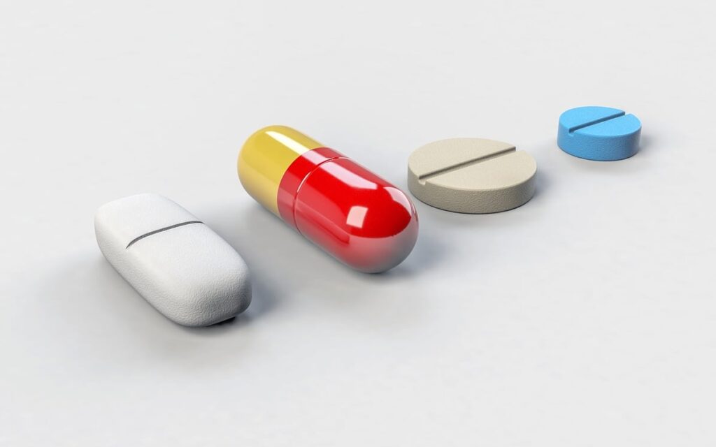 Four pharmaceutical pills representing biopharma innovation trends in 2026.