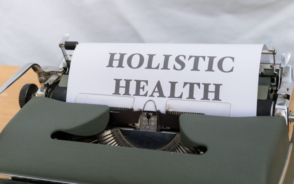 Typewriter with paper reading "Holistic Health" representing holistic GLP-1 care
