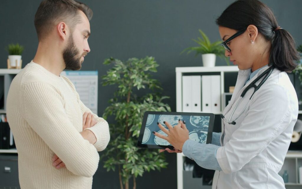 Doctor reviews scan illustrating Clarkson prostate cancer diagnosis with patient